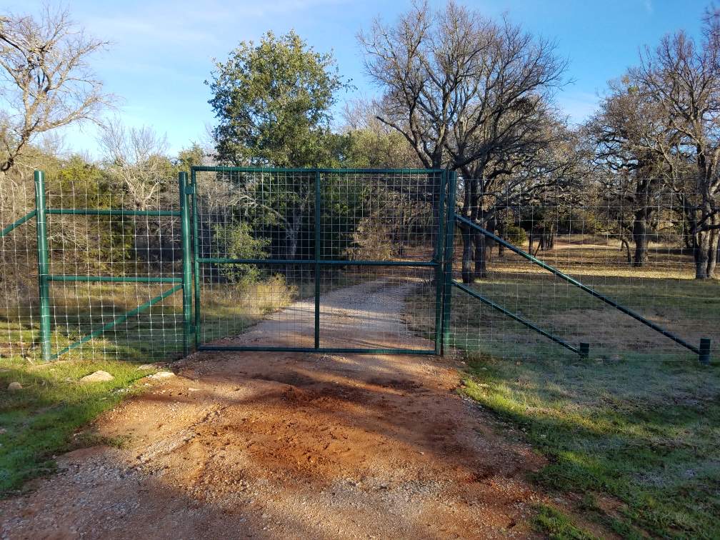 Wide metal equipment barn covering farm machinery near Brownwood TX